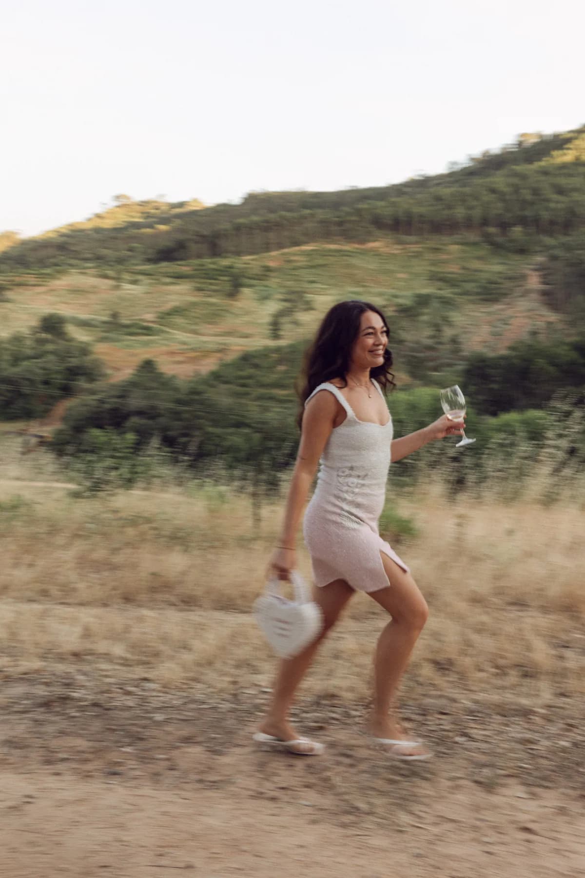 A guest walking through the meadow near the vineyards