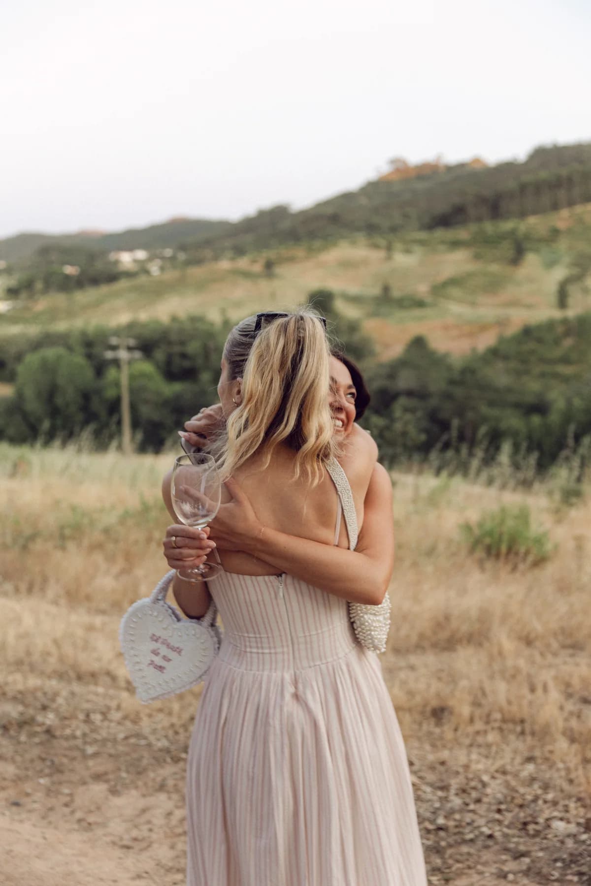 Guests embracing at the countryside welcome party