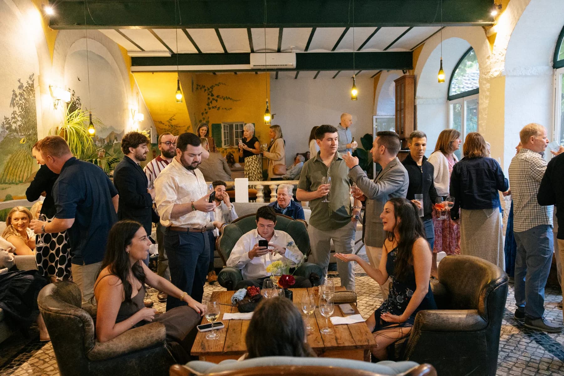 Guests gathering in an indoor lounge with drinks
