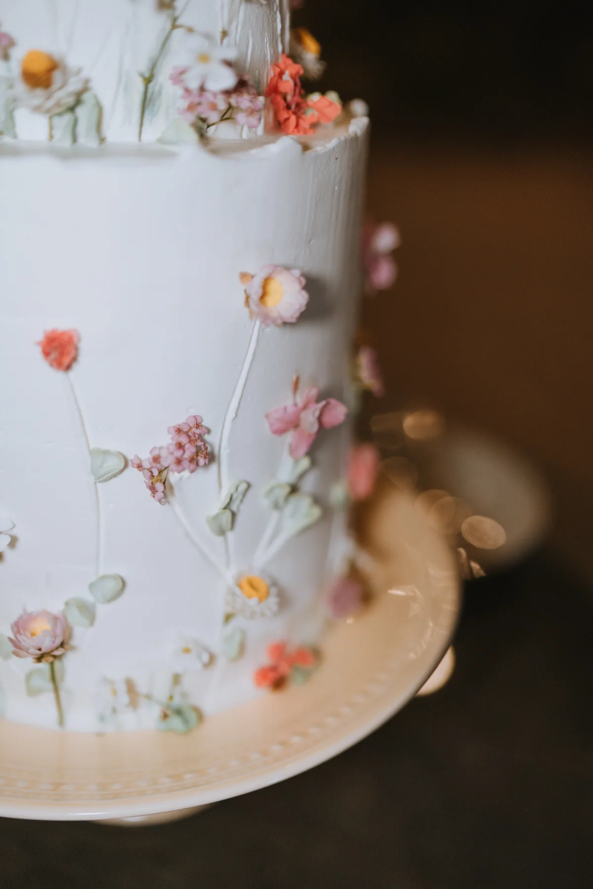 A white wedding cake decorated with delicate flowers