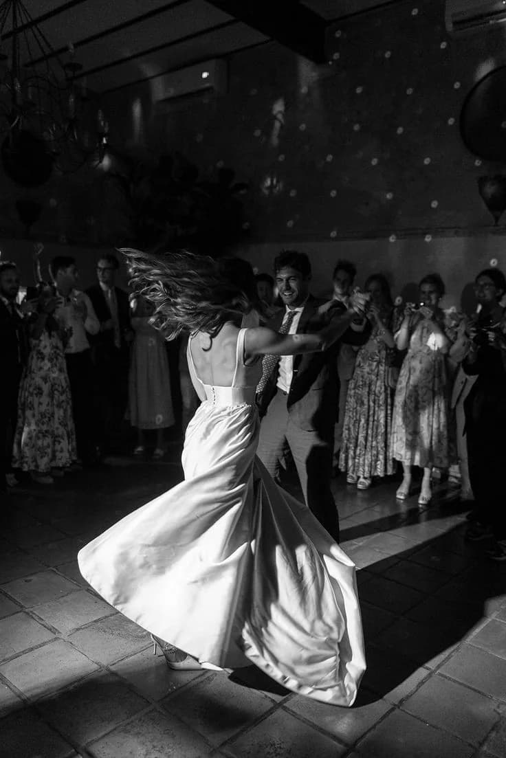 A bride twirling on the dance floor in black and white