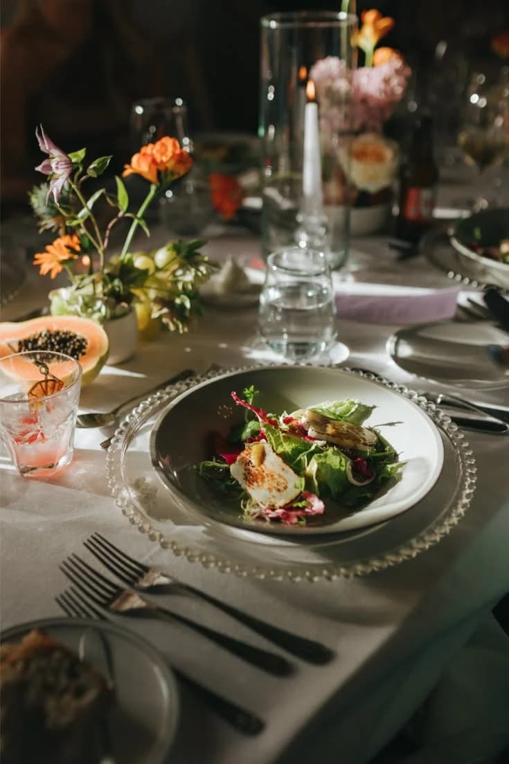 A plated dish at a floral wedding table setting