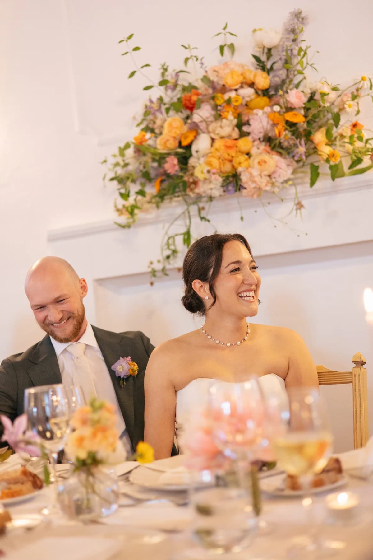 A bride smiling at the wedding dinner table