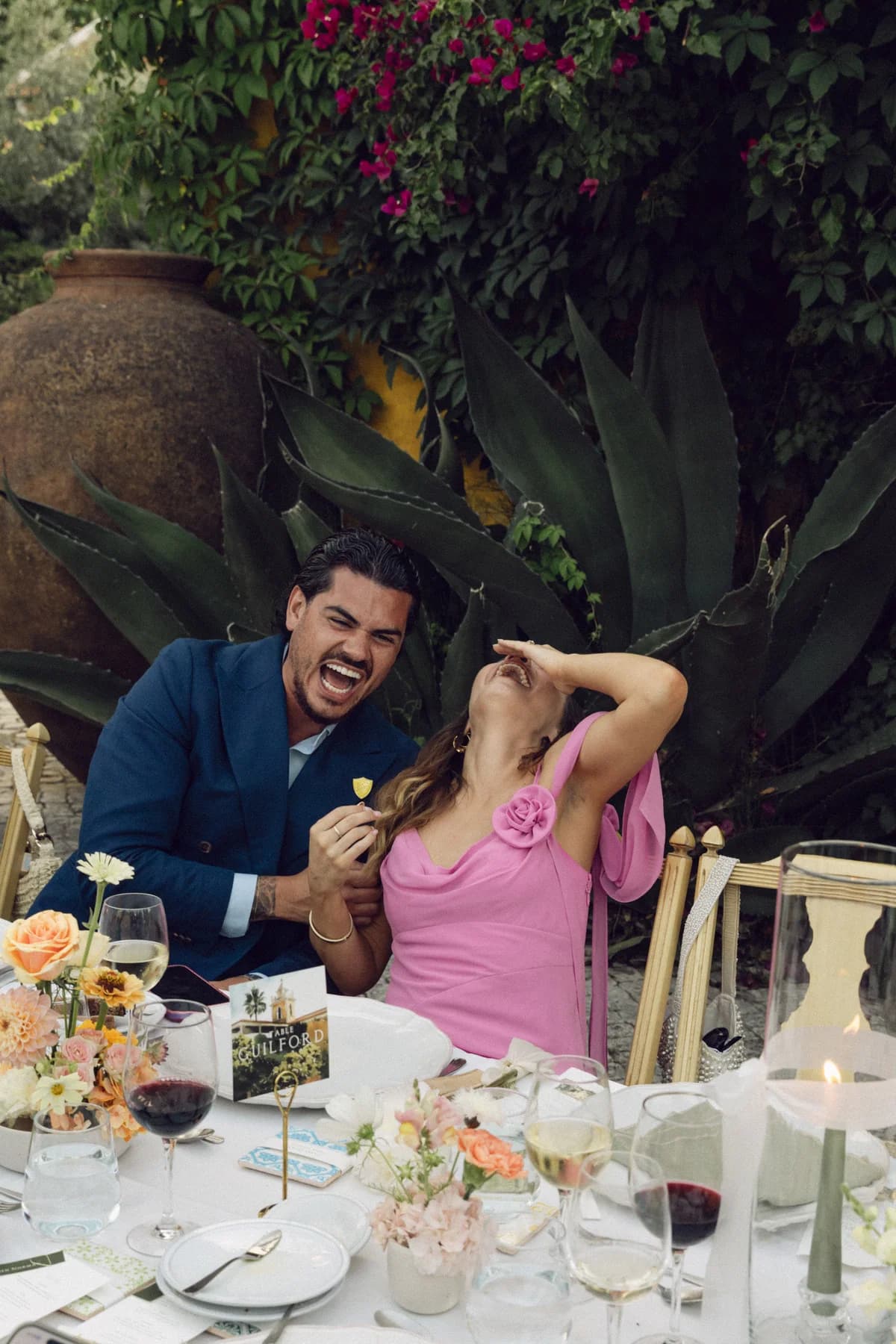 Guests laughing together at the wedding dinner