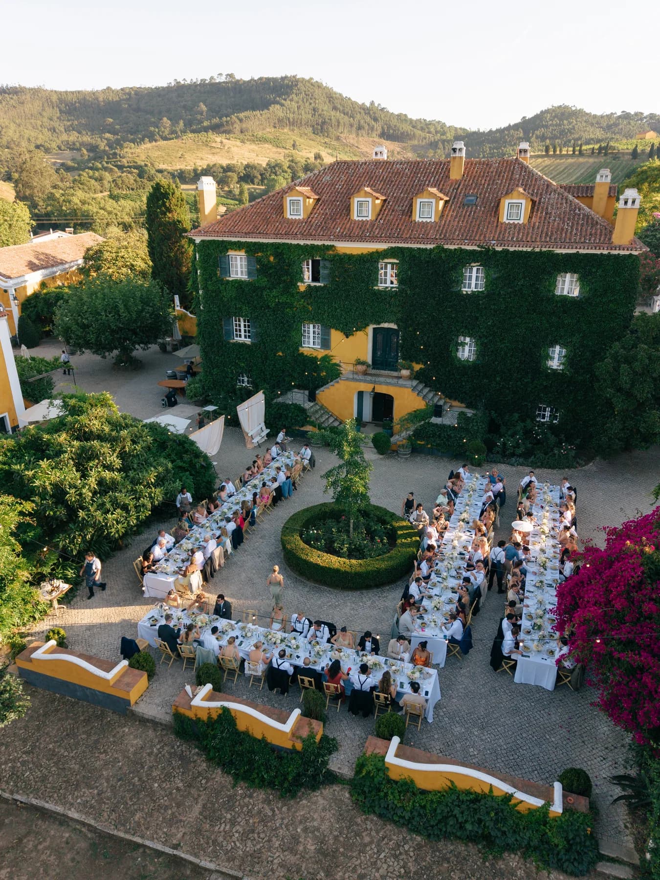 An aerial view of wedding dinner tables in the courtyard