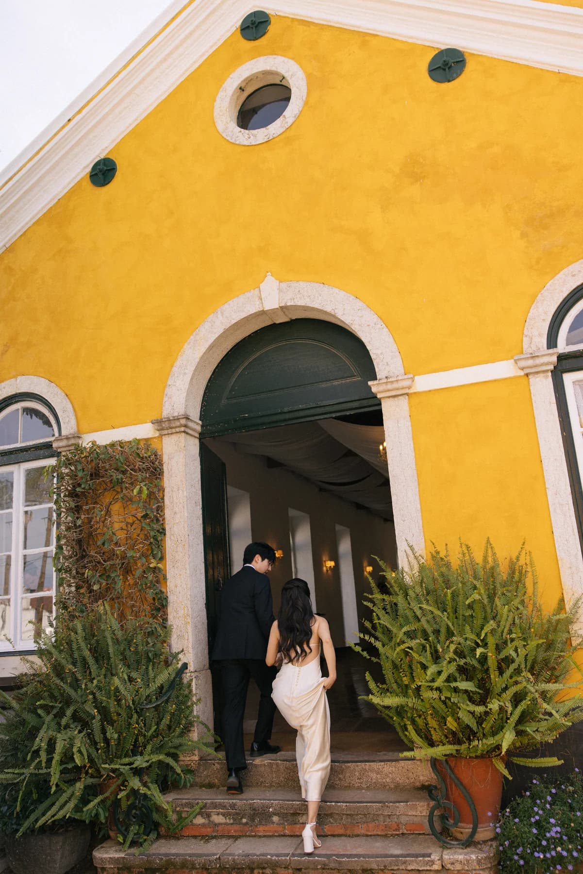 A guest descending the steps of the ochre dining hall