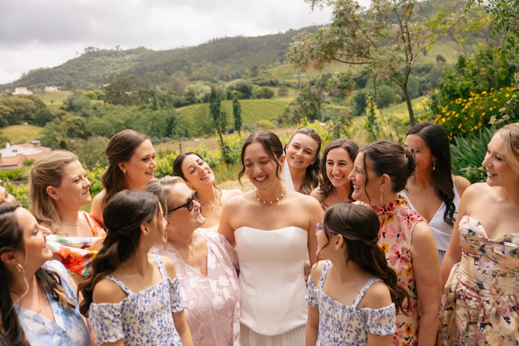 A bride and friends sharing a moment outdoors before the wedding