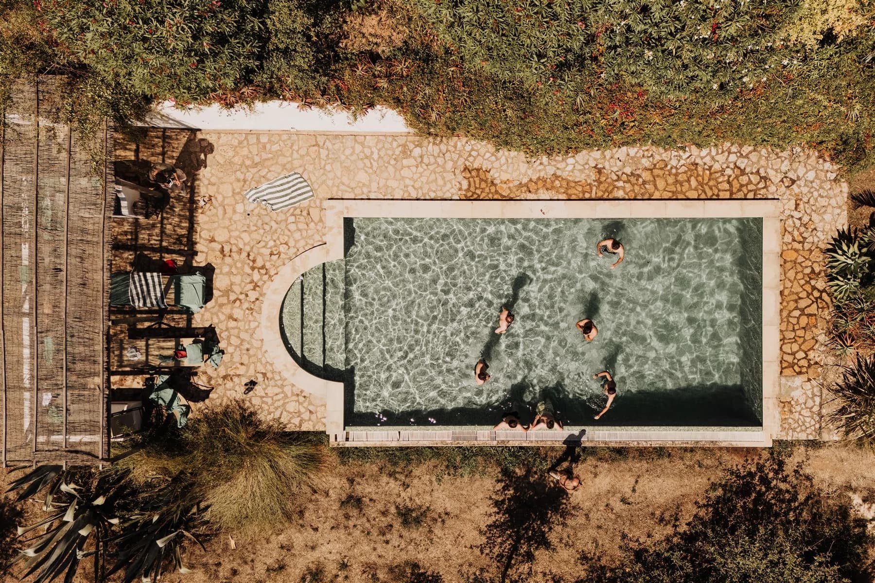 An aerial view of guests swimming in the garden pool