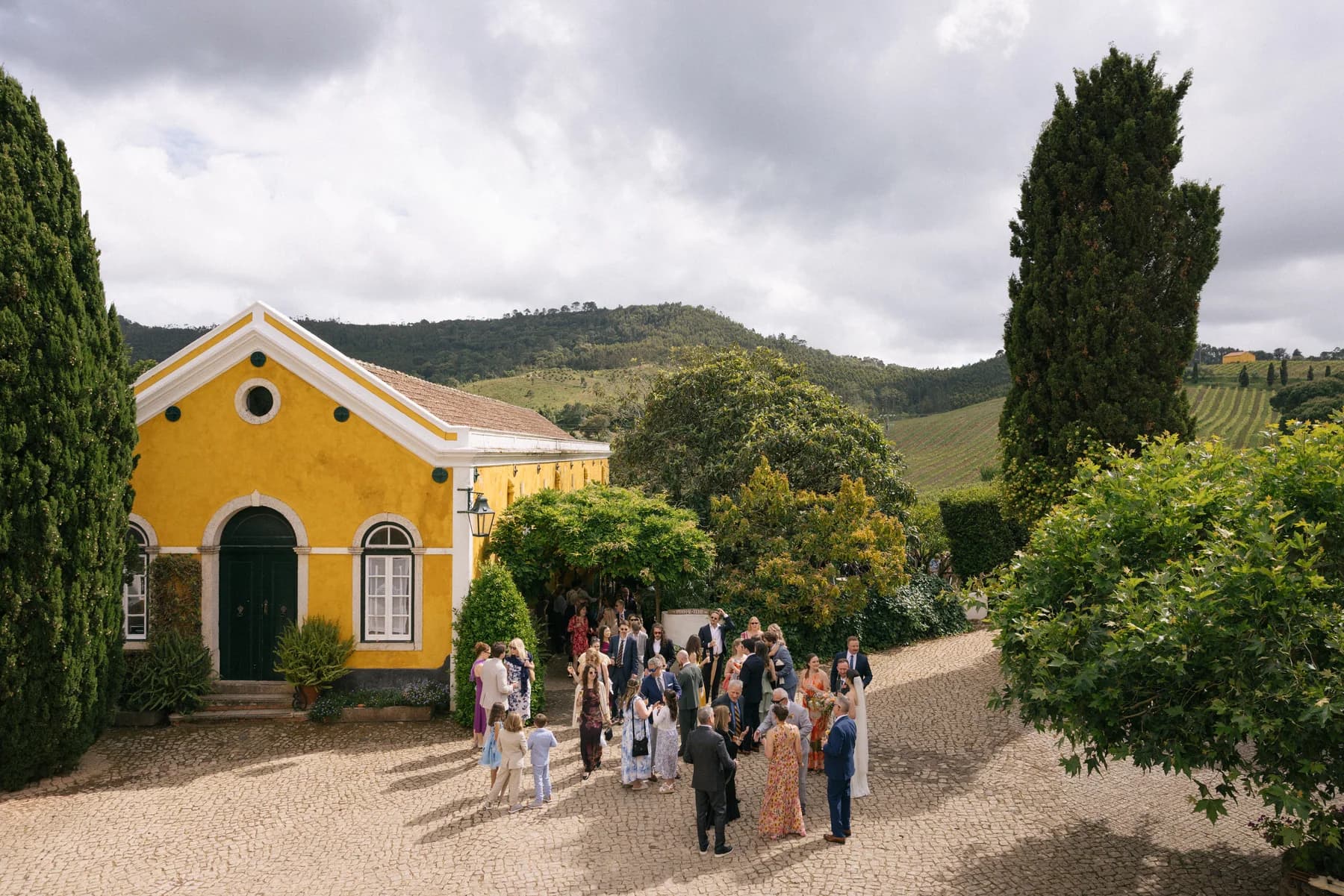 Wedding guests walking outside the estate chapel