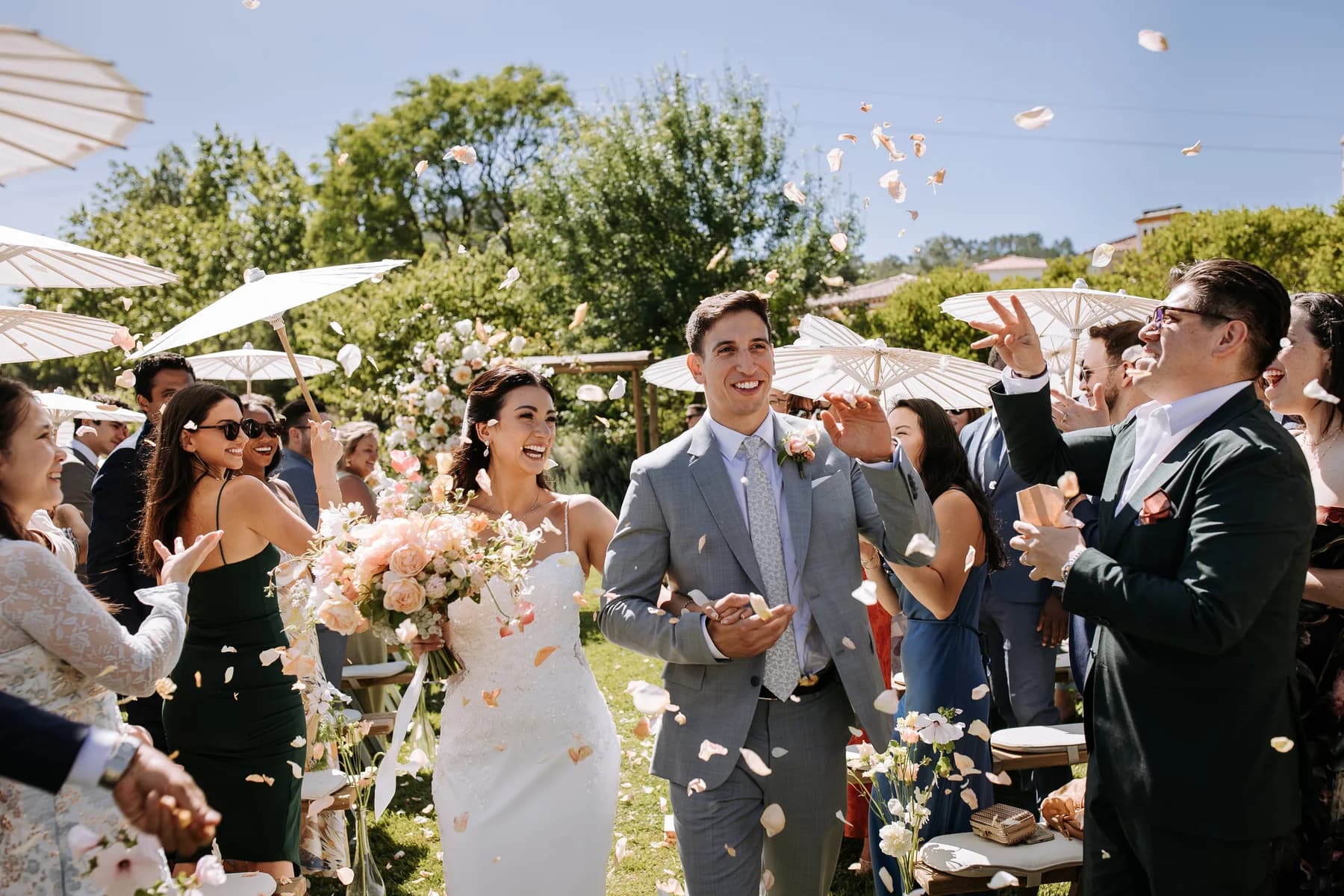 Newlyweds walking through a shower of confetti