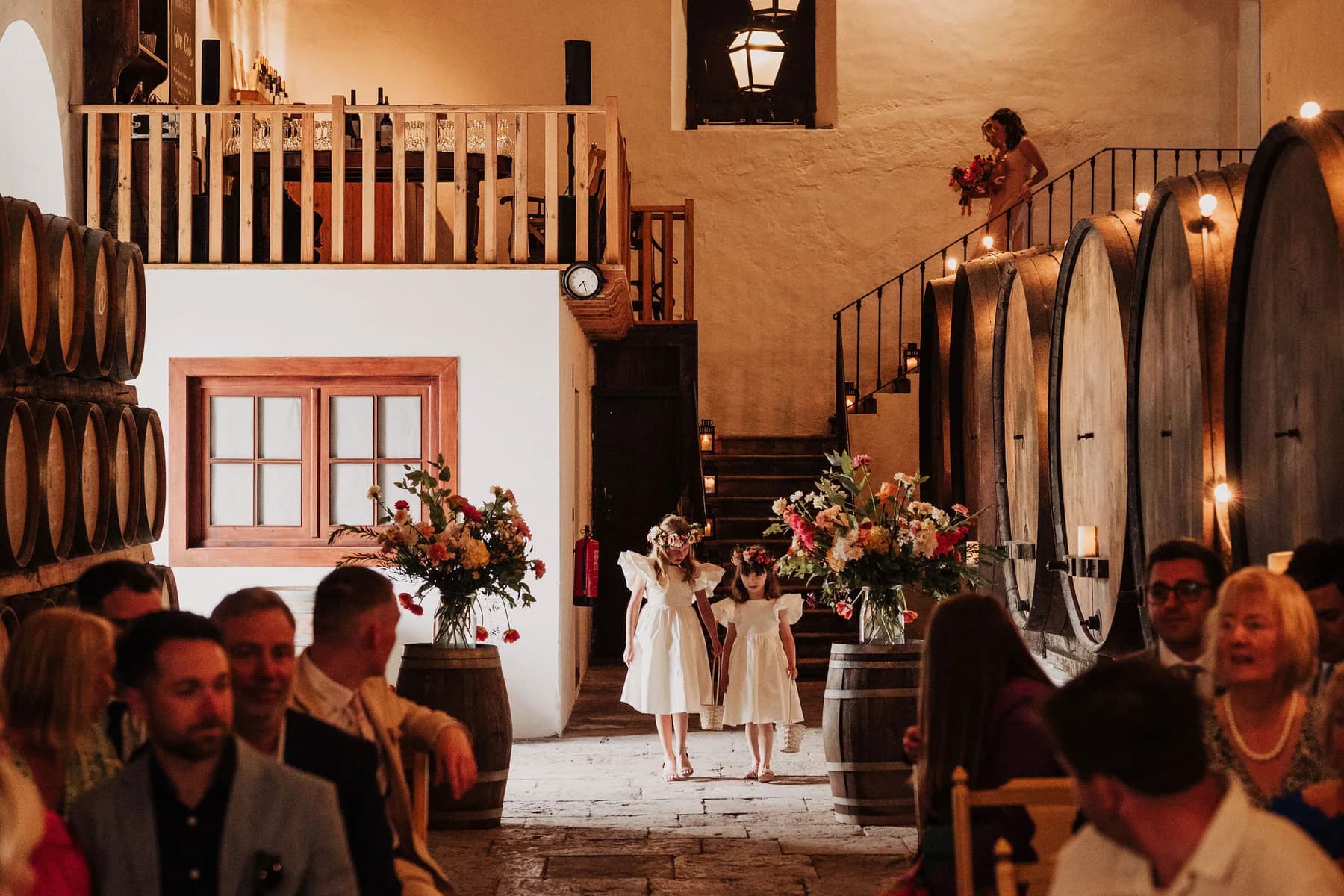 A wedding ceremony among the wine barrels in the Adega