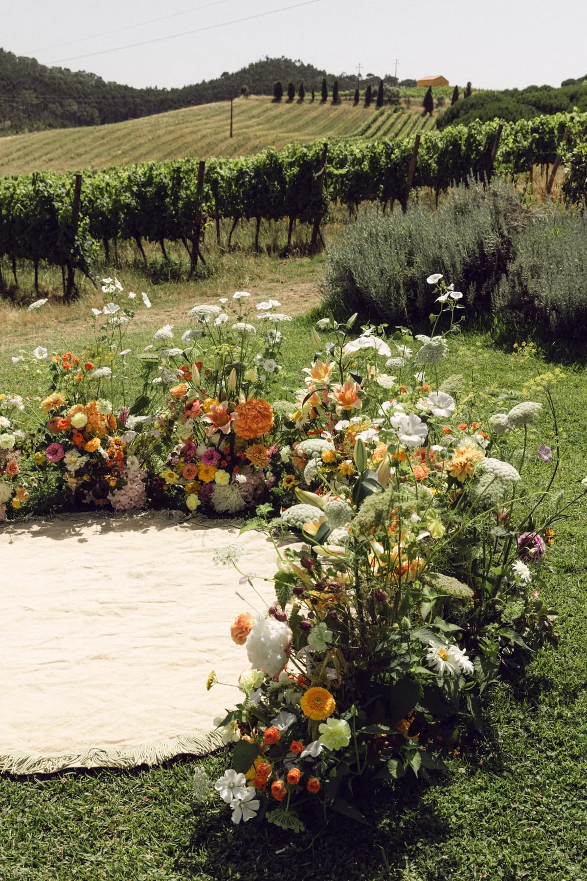 A low floral ceremony arrangement overlooking the vineyards