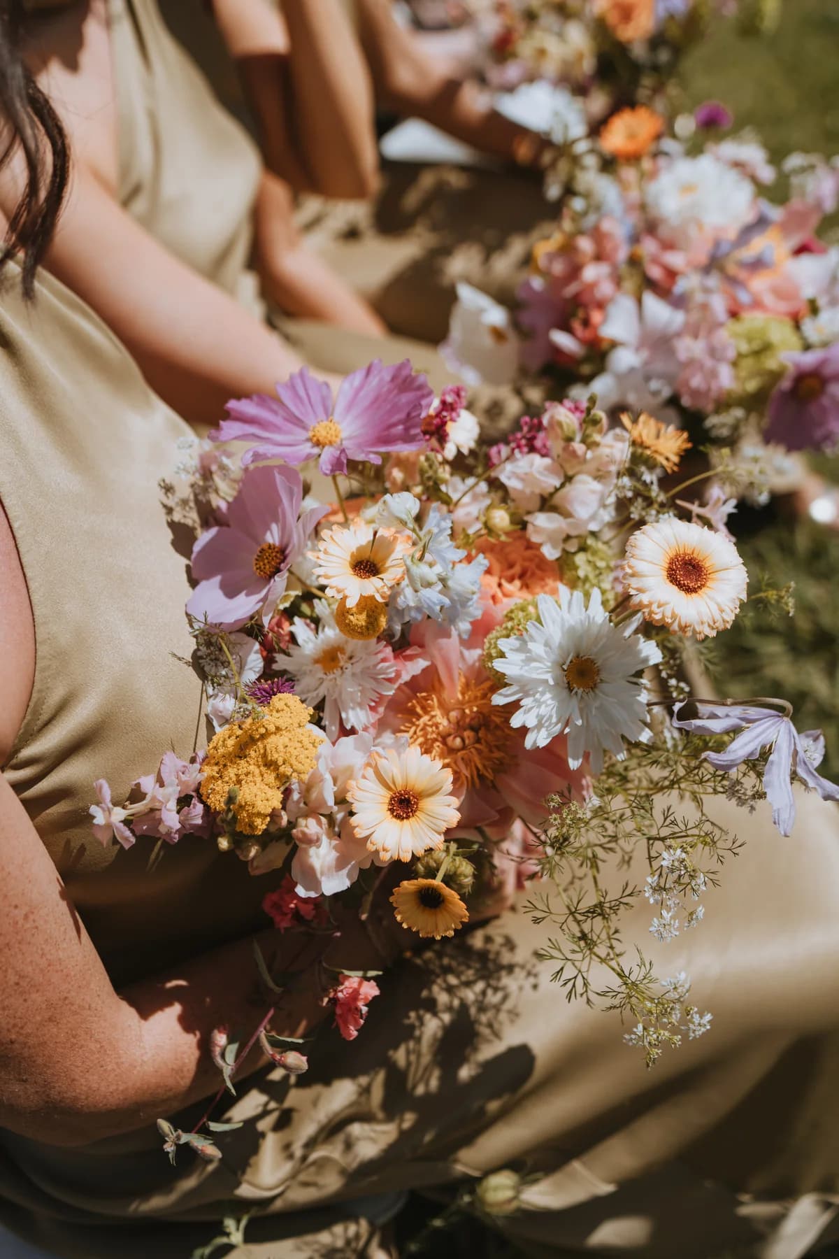 Bridesmaids holding pastel bouquets during the ceremony