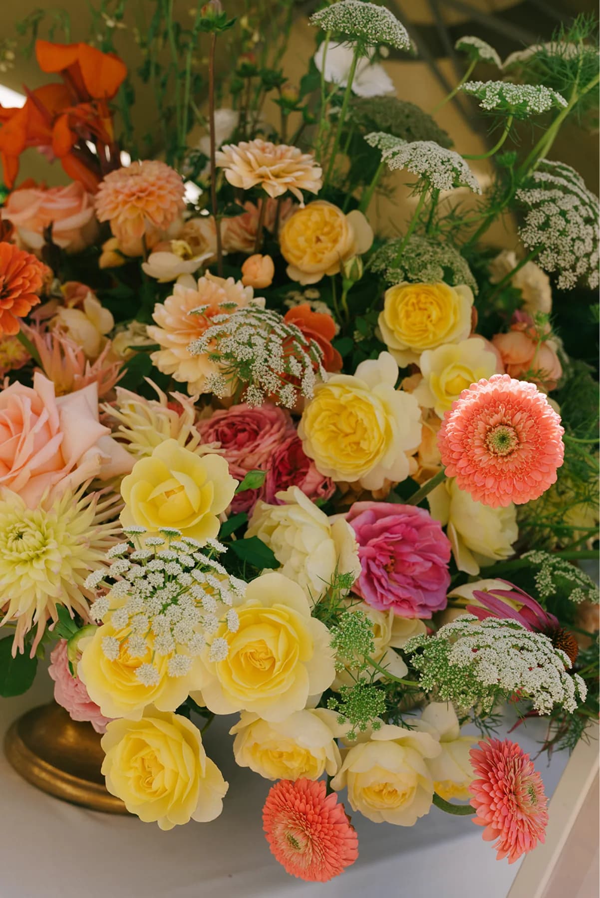 Pink, yellow and peach flowers in a reception arrangement