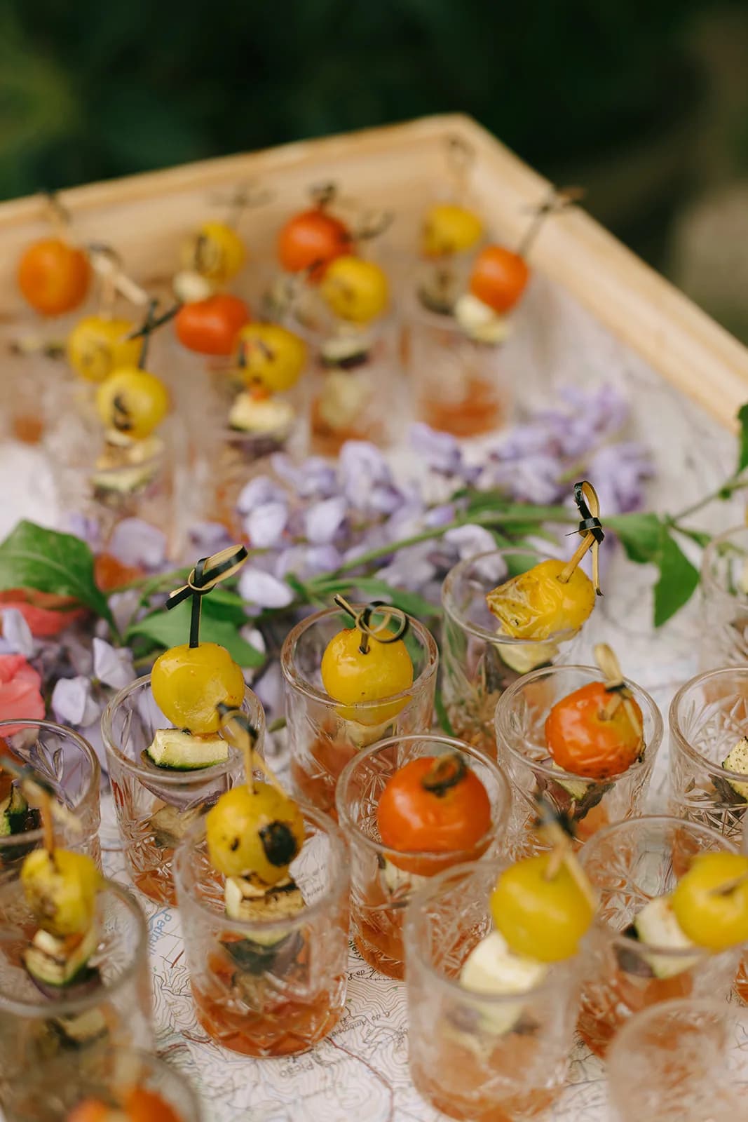 Colourful cocktails garnished with flowers and citrus