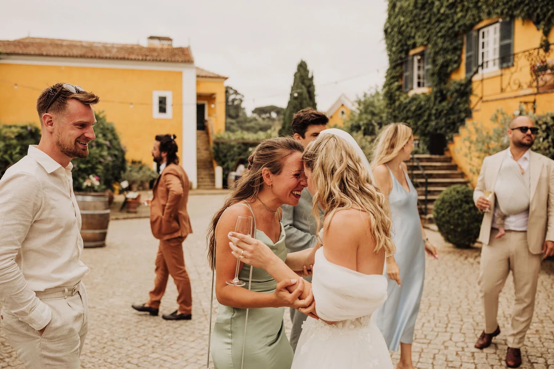 Wedding guests greeting each other in the courtyard