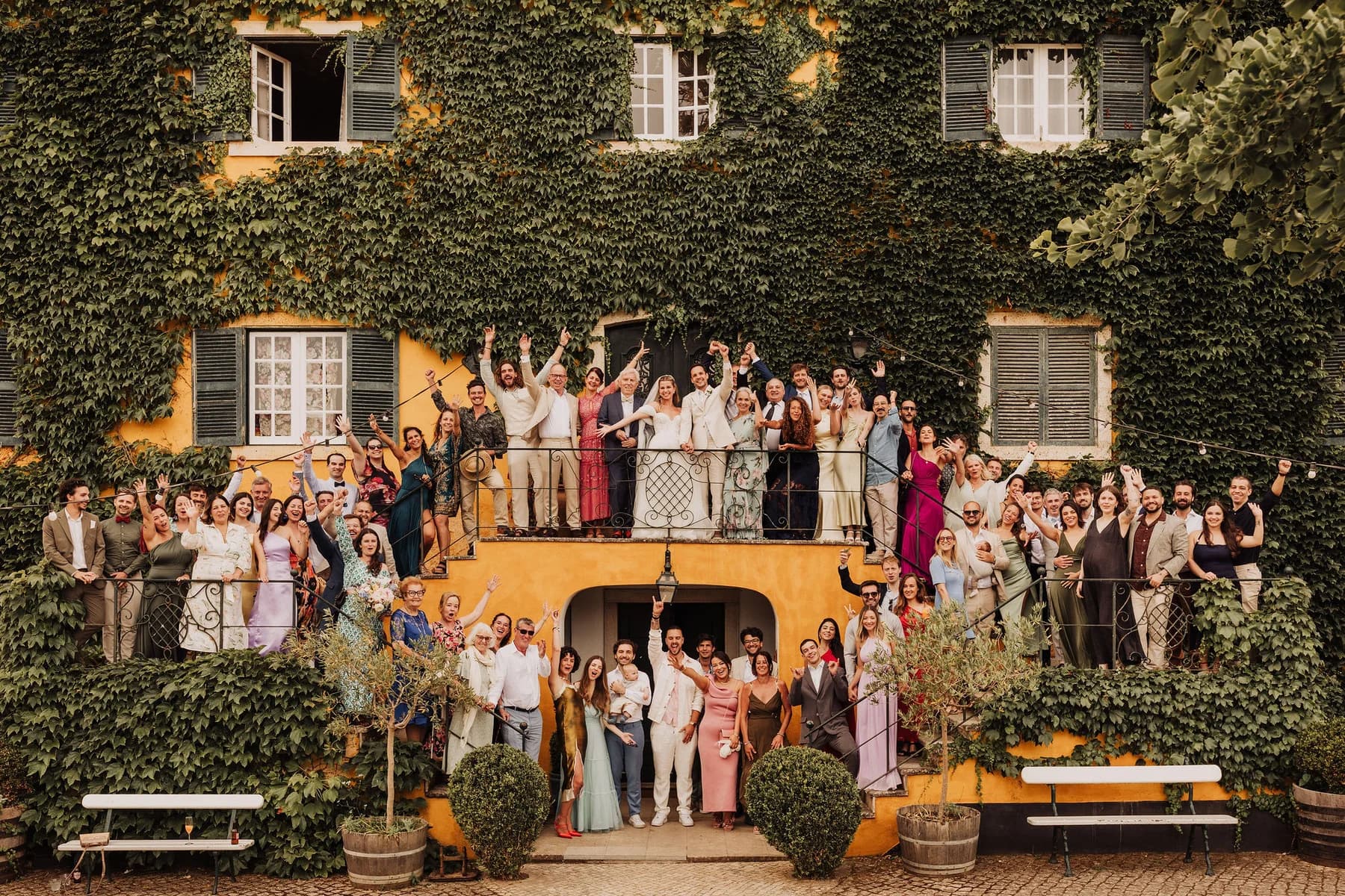 A wedding group gathered on the main house steps