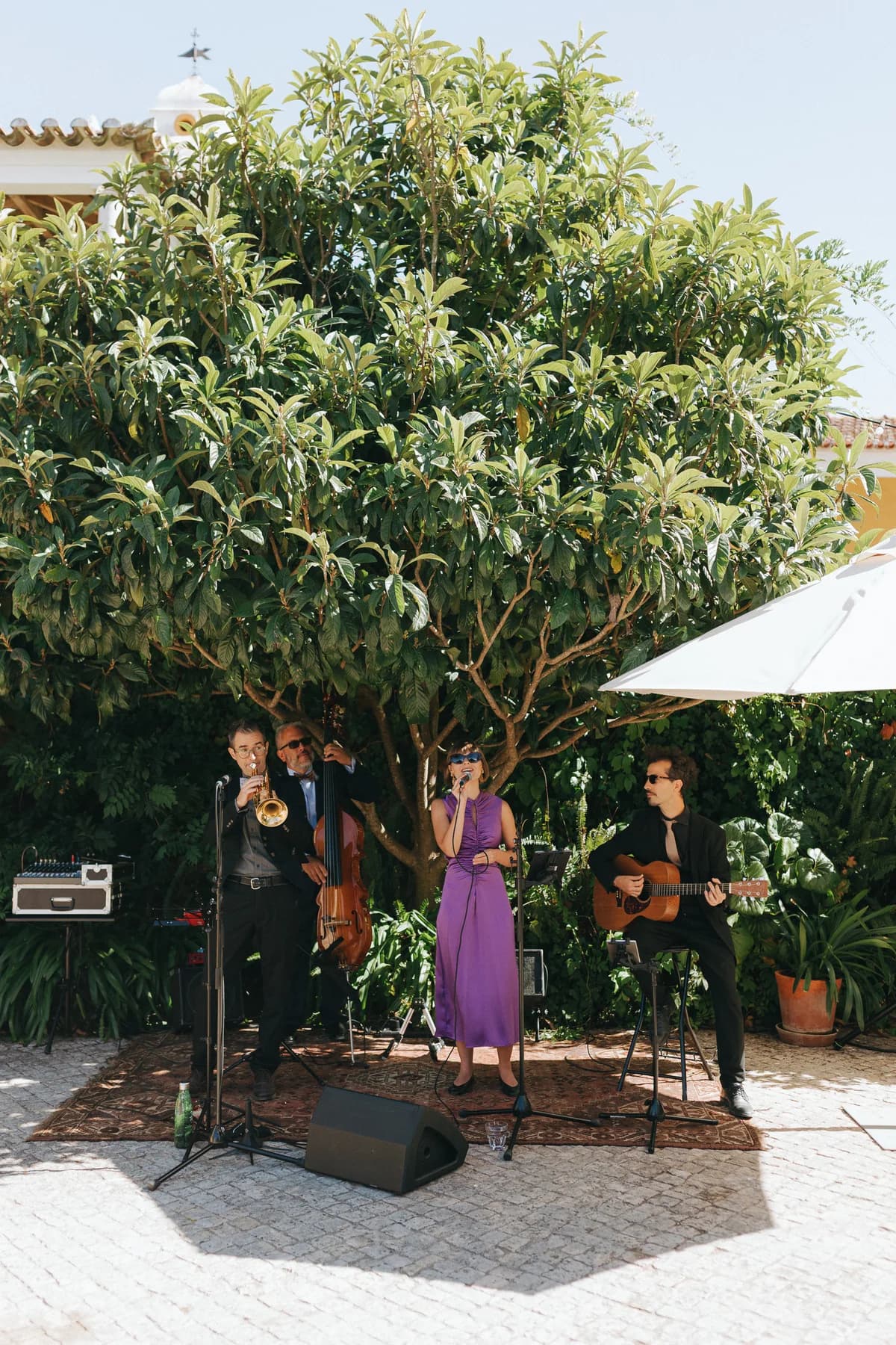 A live band performing outdoors beside the garden