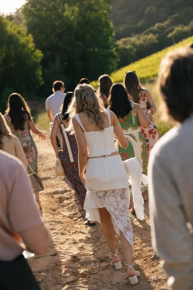 Guests walking together along a vineyard path