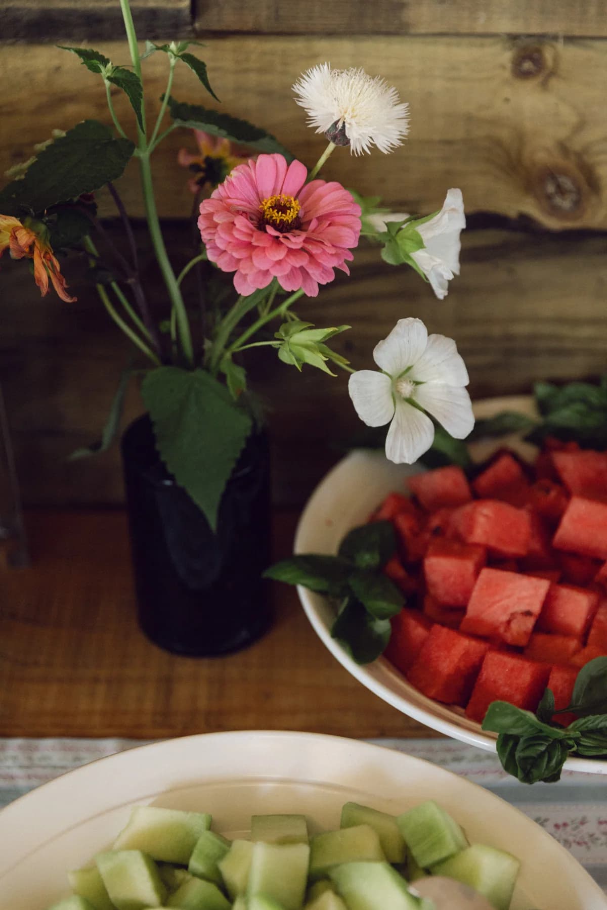 Fresh fruit and flowers on a wooden buffet table