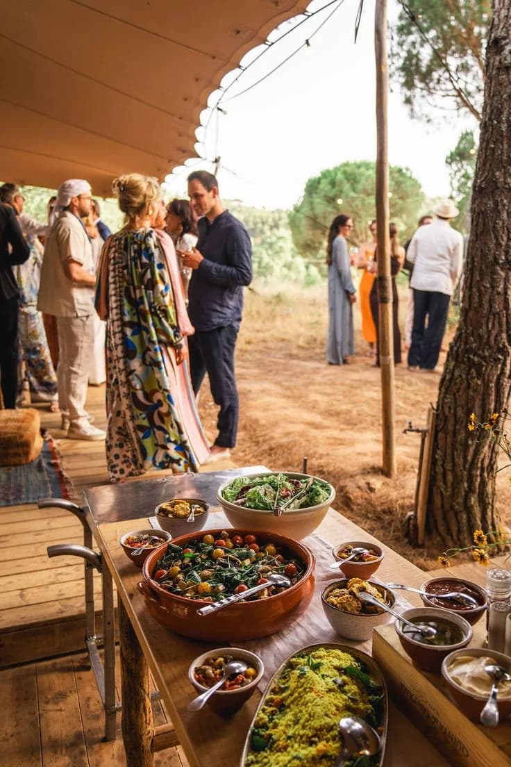 Welcome dinner guests beside a buffet of salads