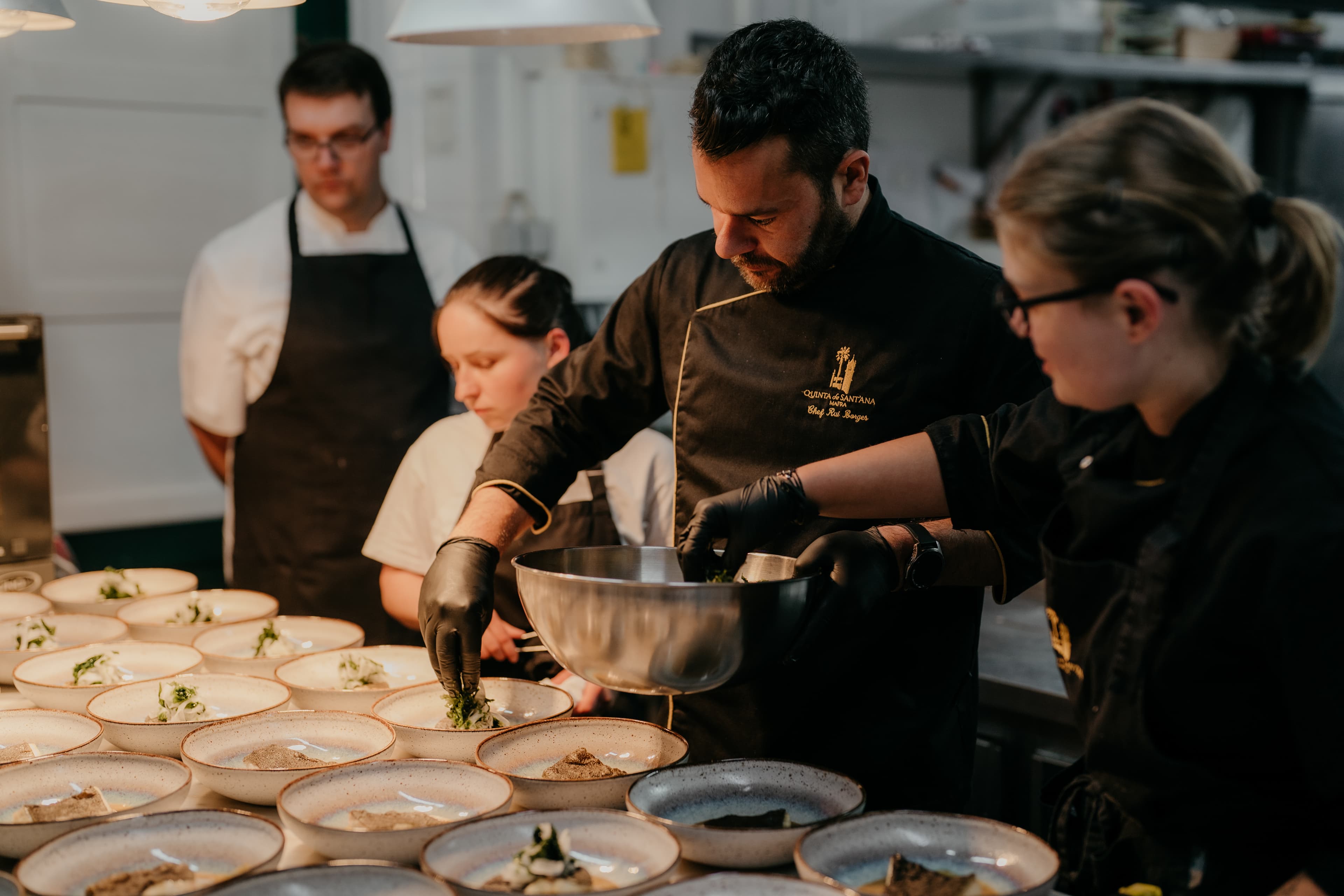 Executive Chef Rui Borges and the Quinta's kitchen team preparing plates together