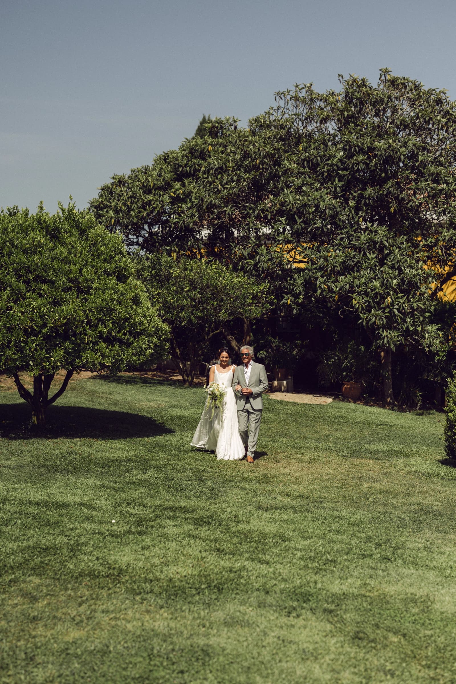 A couple walking together across the garden lawn