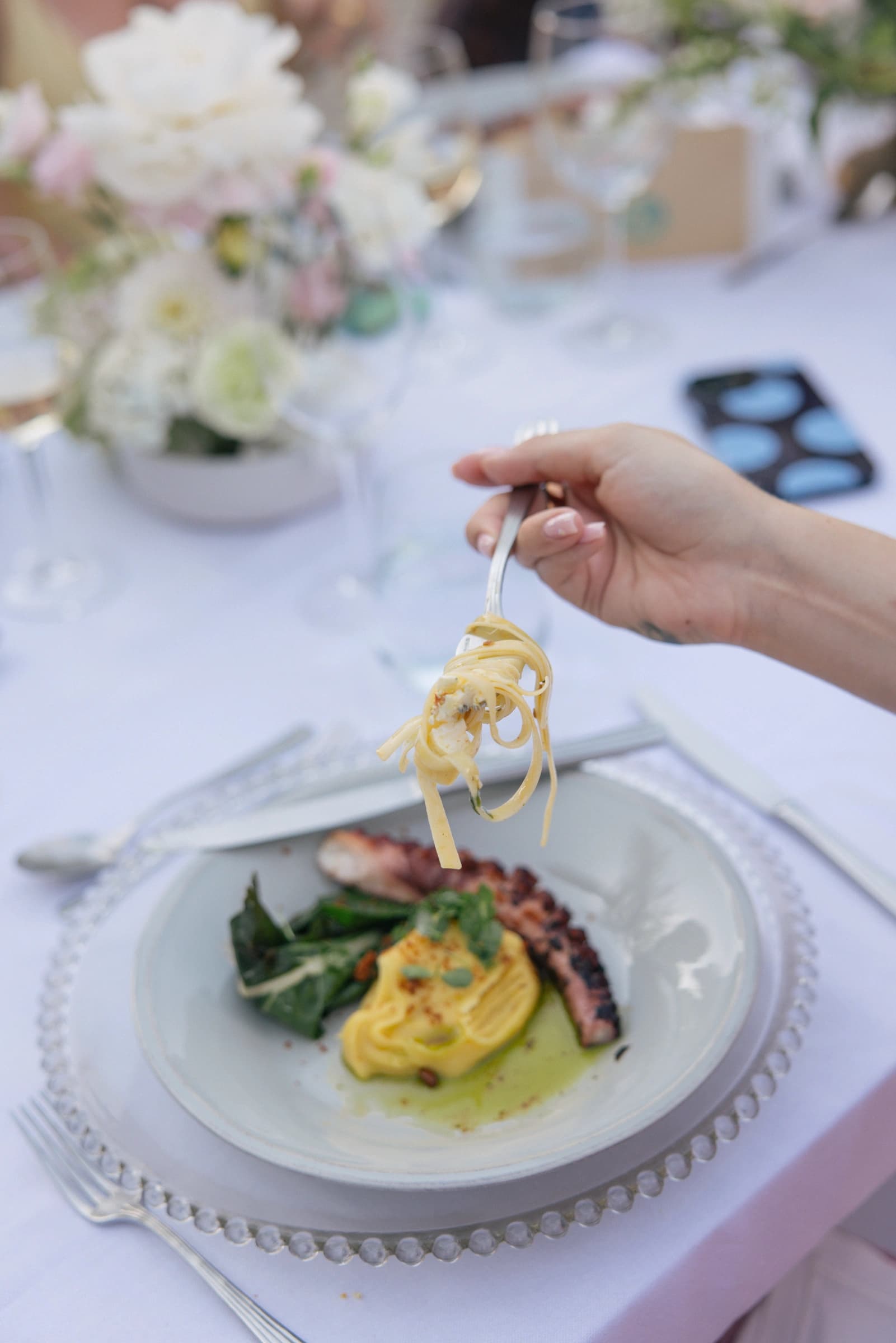 A guest enjoying a plated main course