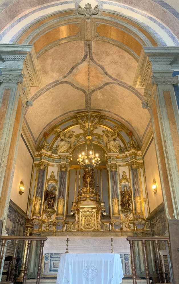 Chapel interior with golden vaulted ceiling and baroque altar