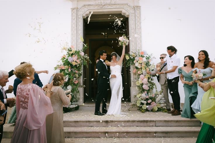 Couple exiting the church with confetti and florals
