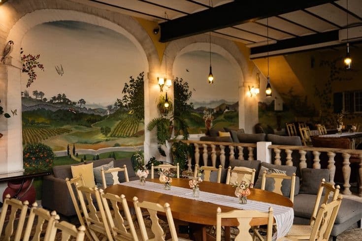 Hand-painted murals and warm pendant lights in the Lagar