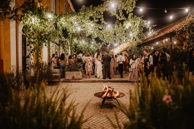 Cobblestone patios with fire pit and string lights