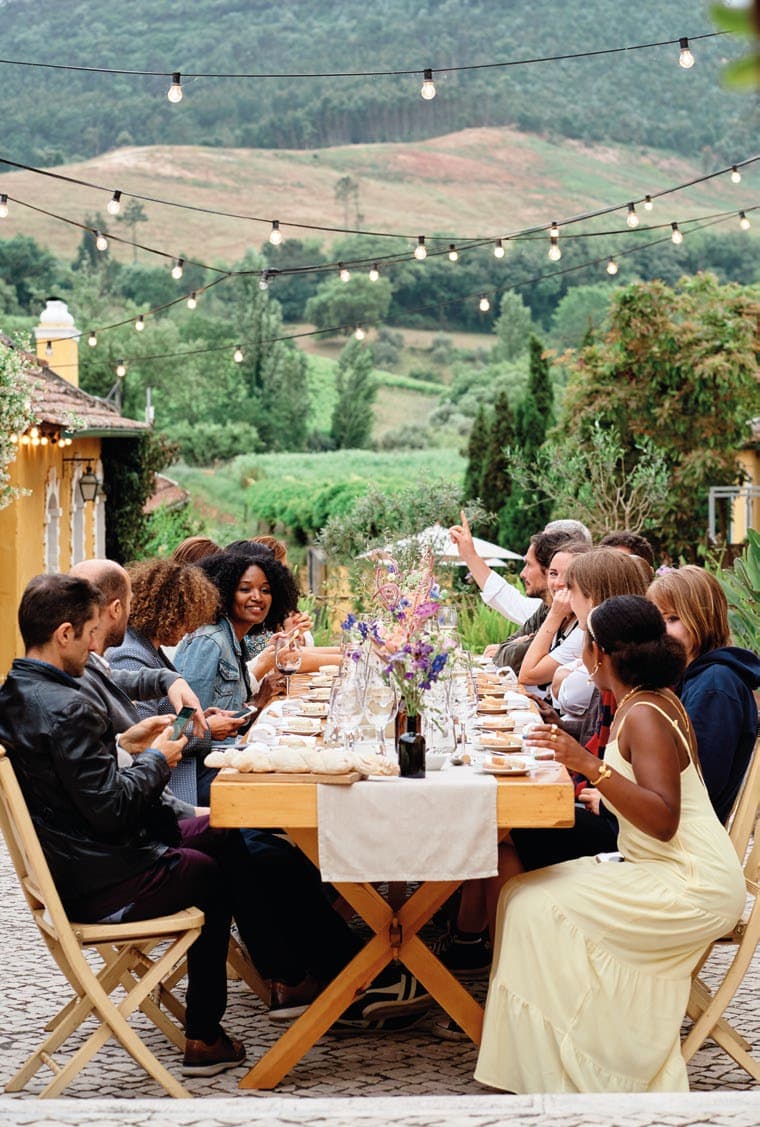 Dinner on the patios with string lights and vineyard hills behind