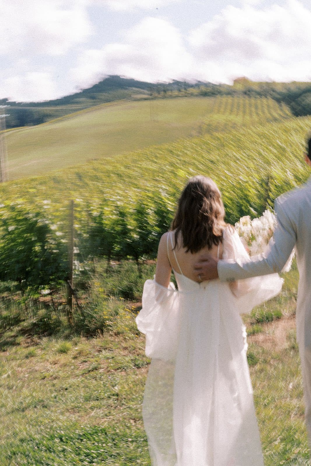 Couple in the vineyard at golden hour