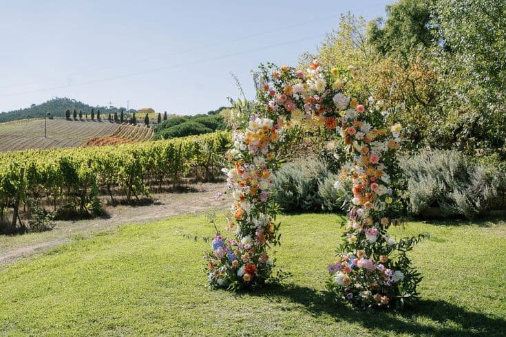 Floral arch with vineyard and hills behind